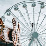 Carnival Rides - Ferris Wheel and Carousel Under White Clouds and Blue Sky