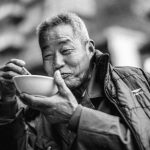 Street Eats - Old Man Eating on Bowl