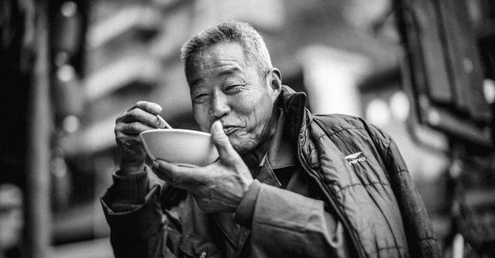 Street Eats - Old Man Eating on Bowl