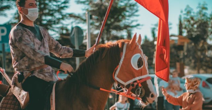 Cultural Parades - A Man Riding a Horse Holding a Turkish Flag