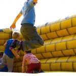 Kids Play - Children Playing on Inflatable Castle