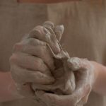 DIY Workshops - Crop faceless woman kneading clay in workshop