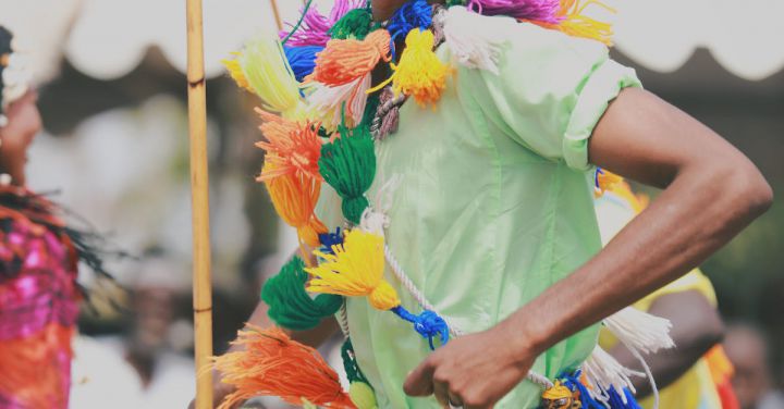 Cultural Parades - A Man Wearing Colorful Attire at the Festival