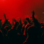 Rock Concerts - a crowd of people at a concert with their hands in the air