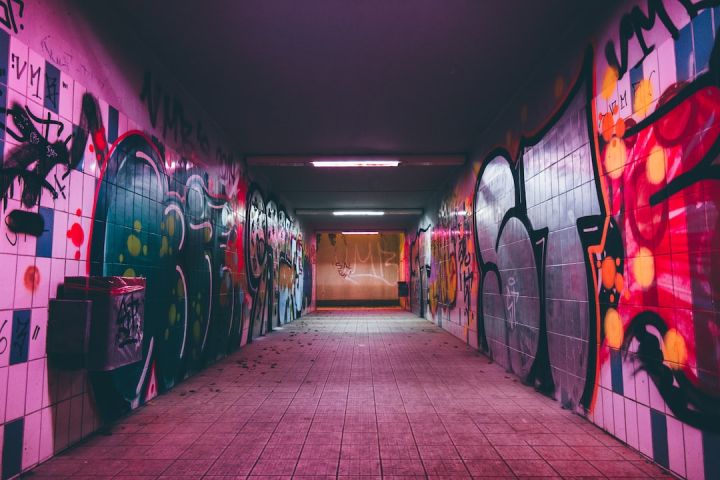 Street Art - empty tunnel pathway with graffiti walls
