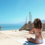 Chill Zone - woman wearing bikini sitting on the sand